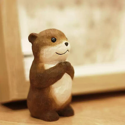 Chibi otter wooden figurine on windowsill in soft light