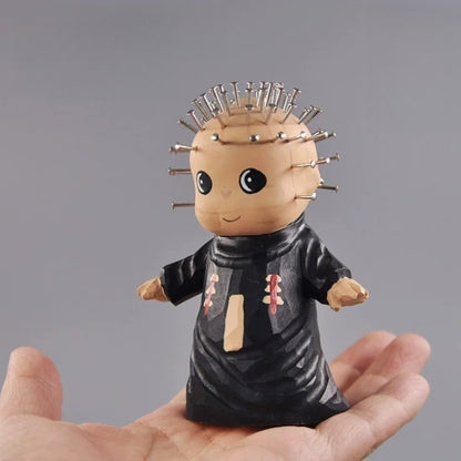 Hand carved chibi pinhead figurine held in hand
