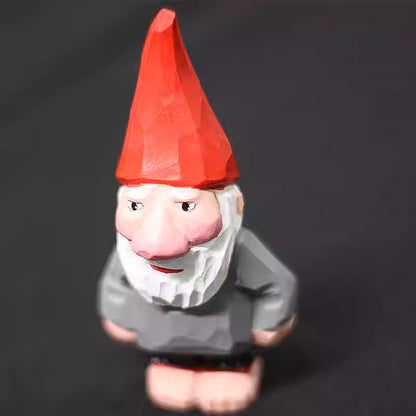 Close view of a wooden Christmas gnome with an oversized nose and pointed red hat