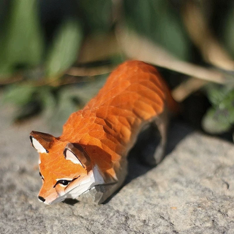 Close-up of crouching red fox figurine