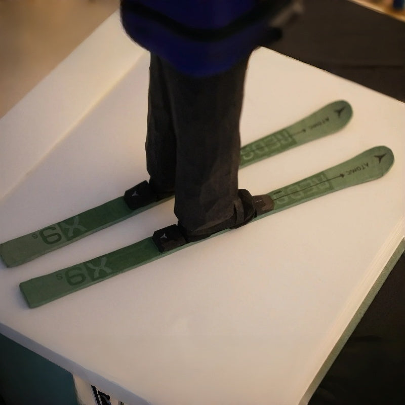 Close-up of skis on custom ski figurine, showing hand carved wooden details and craftsmanship
