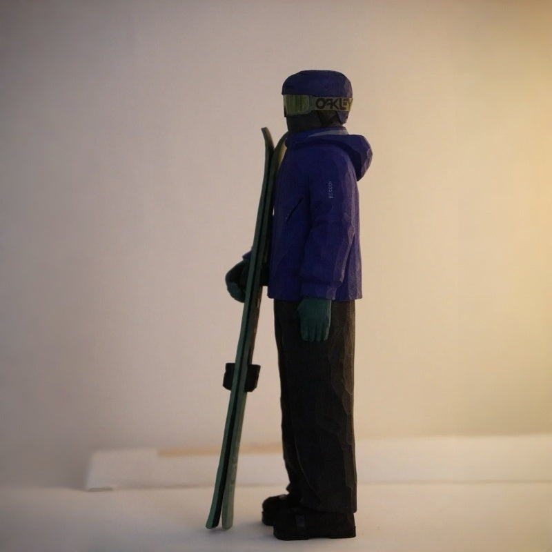 Profile view of custom ski figurine, detailed wooden carving of skier outfit and gear