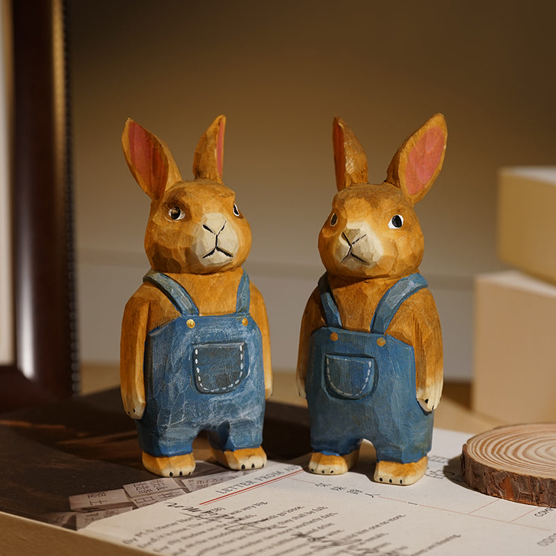 Pair of denim style wooden bunny statues, hand carved and painted.
