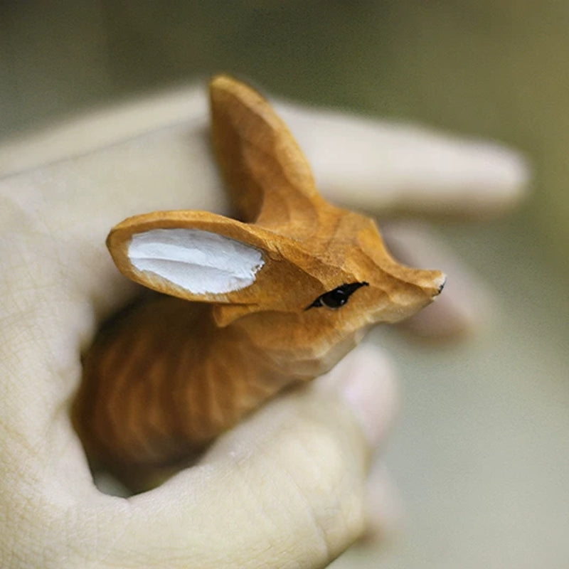 Fennec fox figurine held in hand for scale