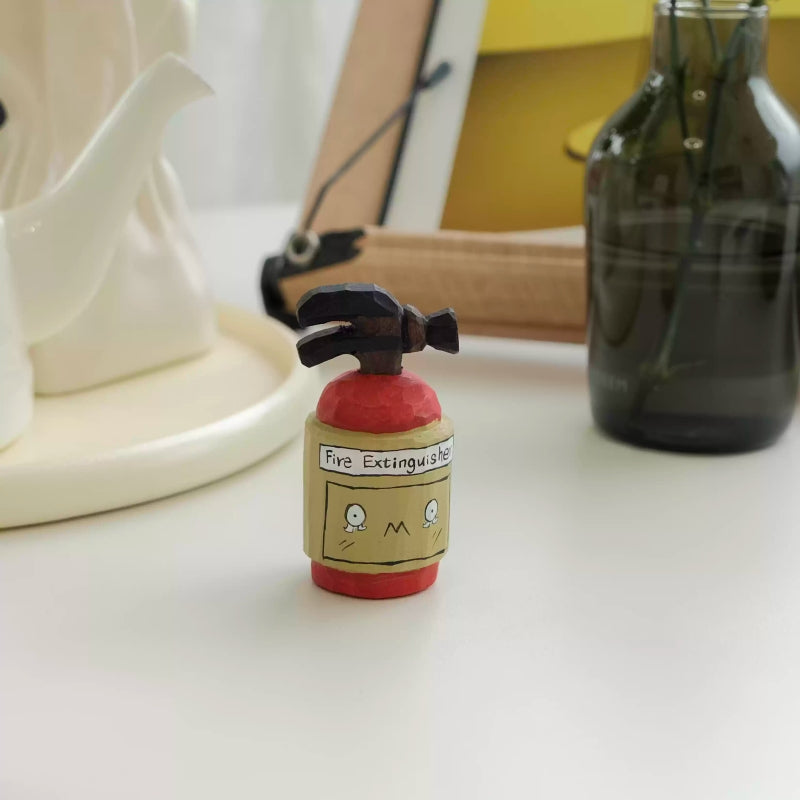 Small wooden fire extinguisher figurine on shelf with decor