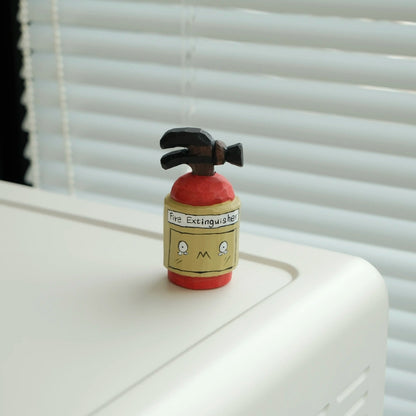 Hand-carved fire extinguisher figurine by window with natural light