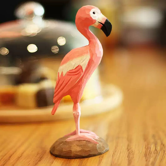 Pink flamingo figurine with layered carved wings