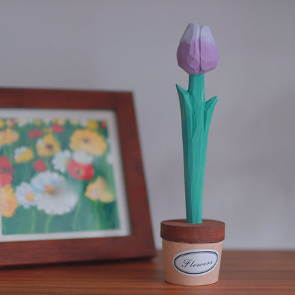 Purple wooden tulip pen in a pot holder with a framed floral painting behind it.