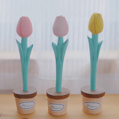 Three wooden tulip pens with pink and yellow blooms standing in individual wooden pot holders.