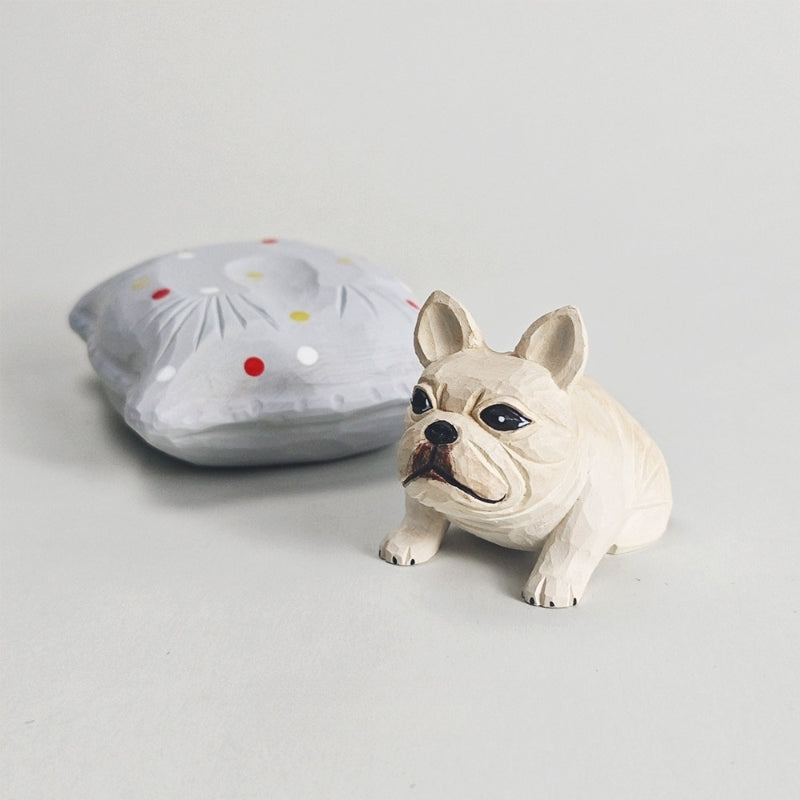 Frenchie figurine displayed beside its detachable gray cushion