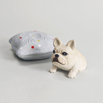 Frenchie figurine displayed beside its detachable gray cushion