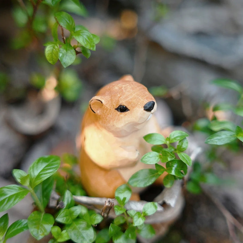 Groundhog figurine among small leaves and foliage