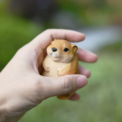 Groundhog figurine held in hand for scale