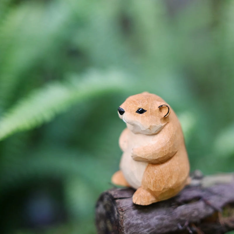Three-quarter view of groundhog wooden figurine on log