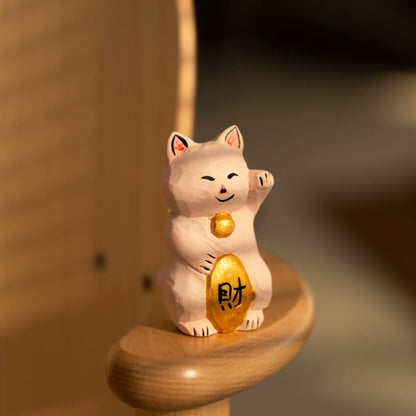 Hand carved maneki neko figurine holding fortune ingot
