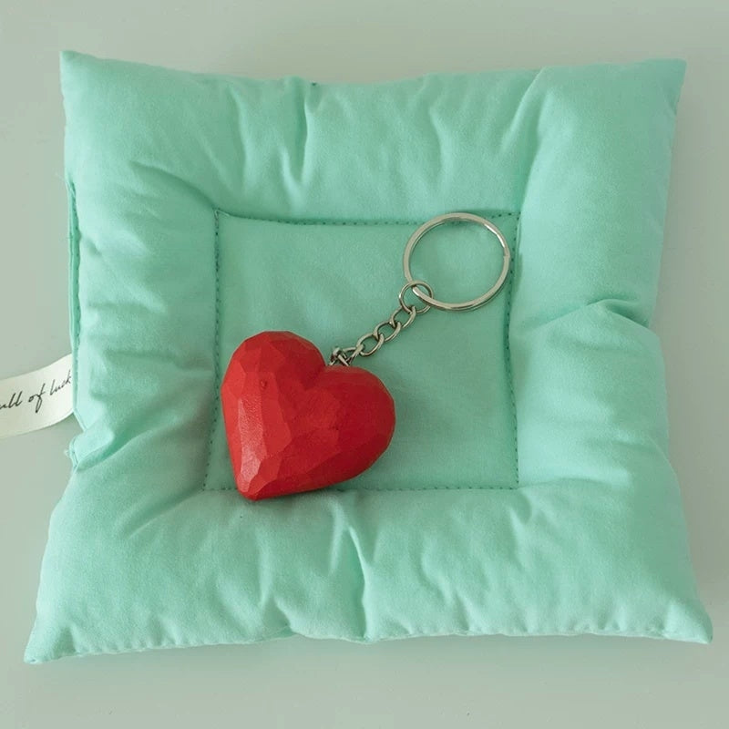 Heart keychain on mint cushion