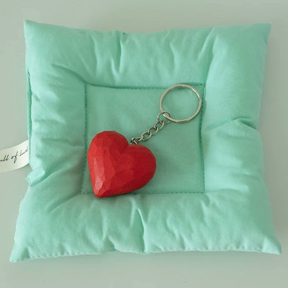Heart keychain on mint cushion