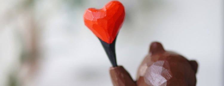 Homepage hero banner showing a hand-carved wooden heart, representing the warmth of handmade wooden gifts from Wooden Smile.