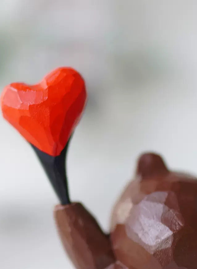 Homepage hero banner showing a hand-carved wooden heart, representing the warmth of handmade wooden gifts from Wooden Smile.