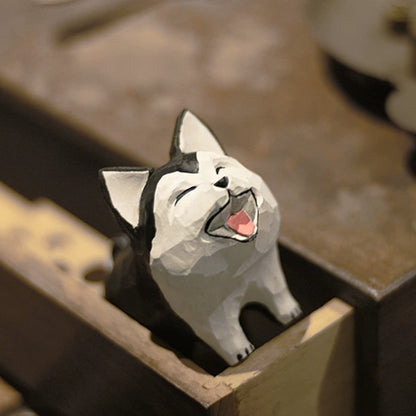 Husky dog figurine peeking from an open wooden drawer with a wide painted smile