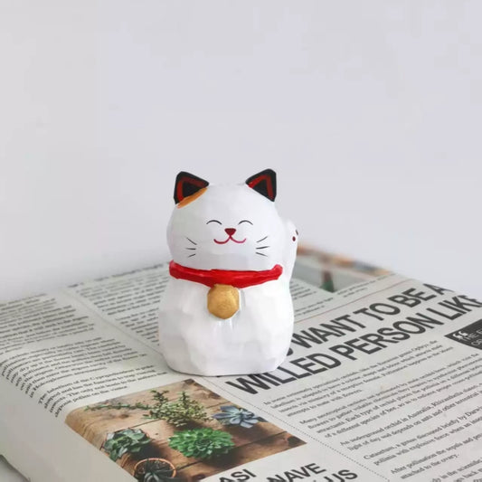 Japanese lucky cat figurine with single paw raised