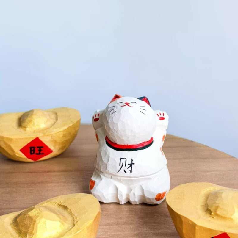 Japanese lucky cat figurine with gold ingots