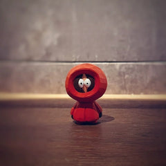 Kenny figurine on a wooden surface