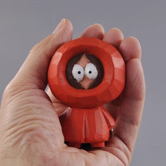 Kenny figurine held in hand for size