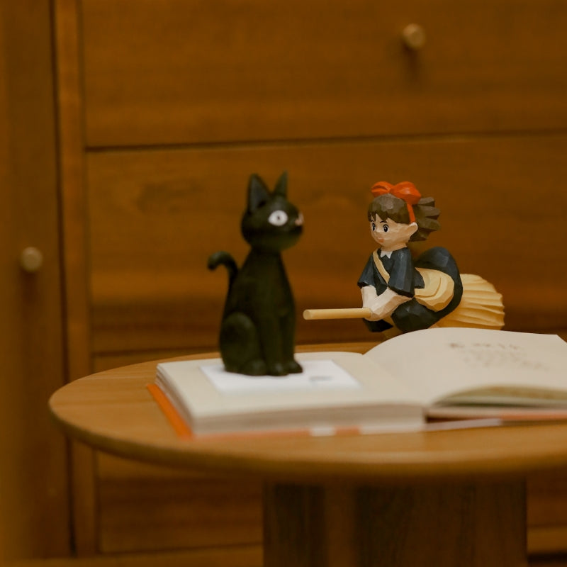 Kiki and black cat wooden figurine set on table