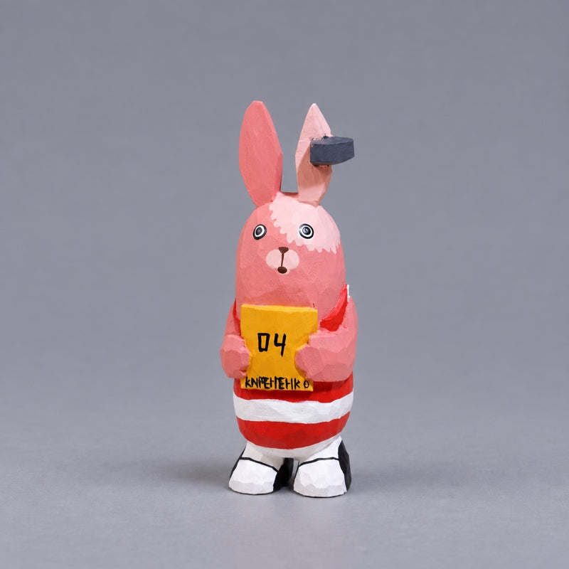 Kirenenko wooden Usavich figure in red-and-white stripes holding a yellow sign
