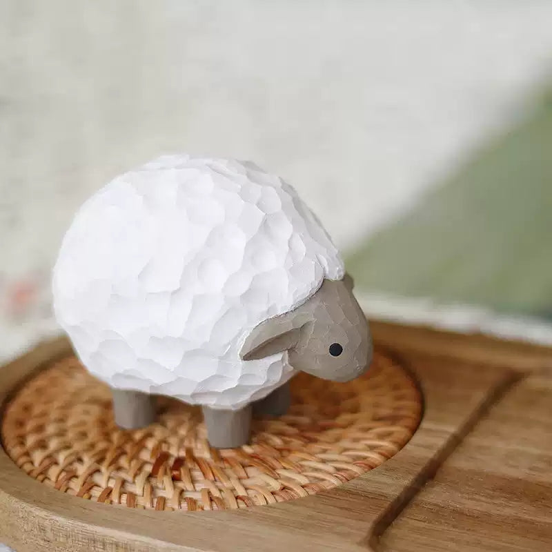 Lamb wooden figurine on rattan tray