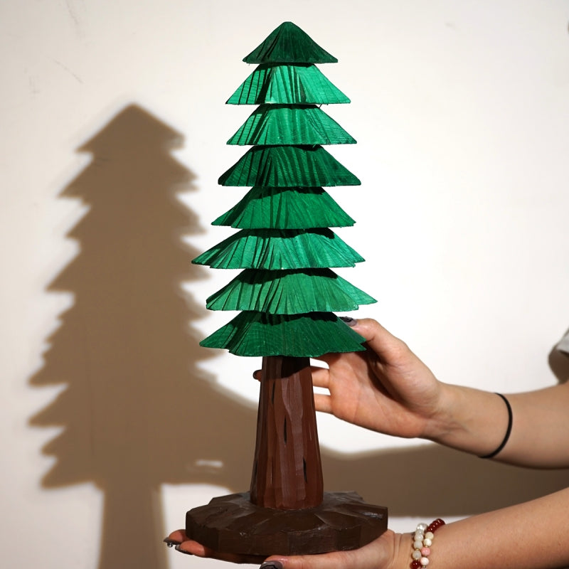 Large 3D wooden Christmas tree held by hand to show its layered construction and scale