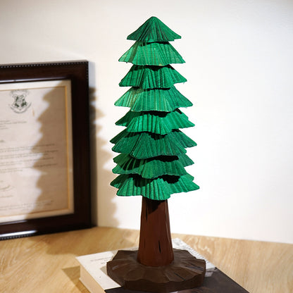 Large wooden Christmas tree with eight layered green tiers and a carved wooden base