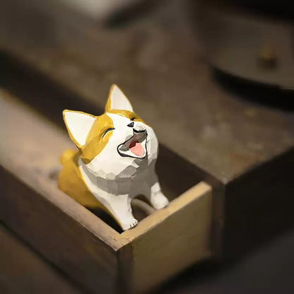 Miniature laughing Corgi peeking from an open wooden box