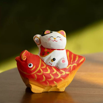 Lucky cat figurine on red koi close up