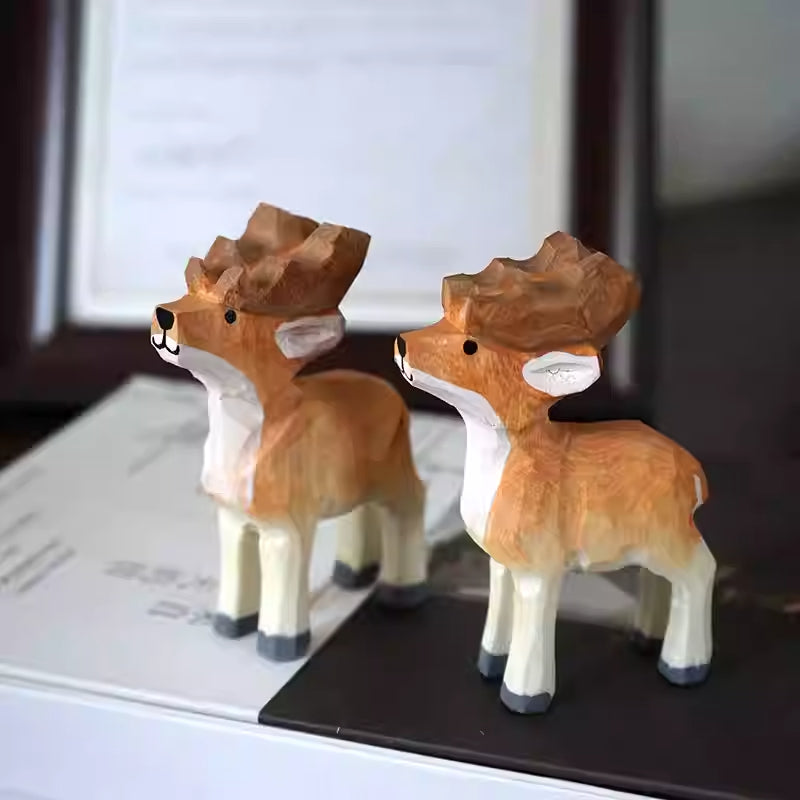 Matching wooden reindeer pair standing together in side view