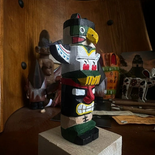 Miniature totem pole figurine in shelf display