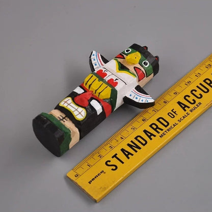 Miniature totem pole wooden figurine with ruler for scale