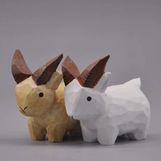 Natural and white goat figurines displayed as a pair