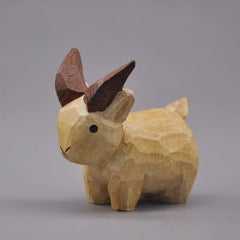 Natural wooden goat figurine with oversized brown horns