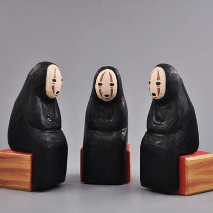 Three No Face Figure sculptures arranged in a triangle formation.
