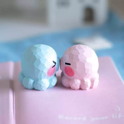 Pair of octopus figurines nose to nose