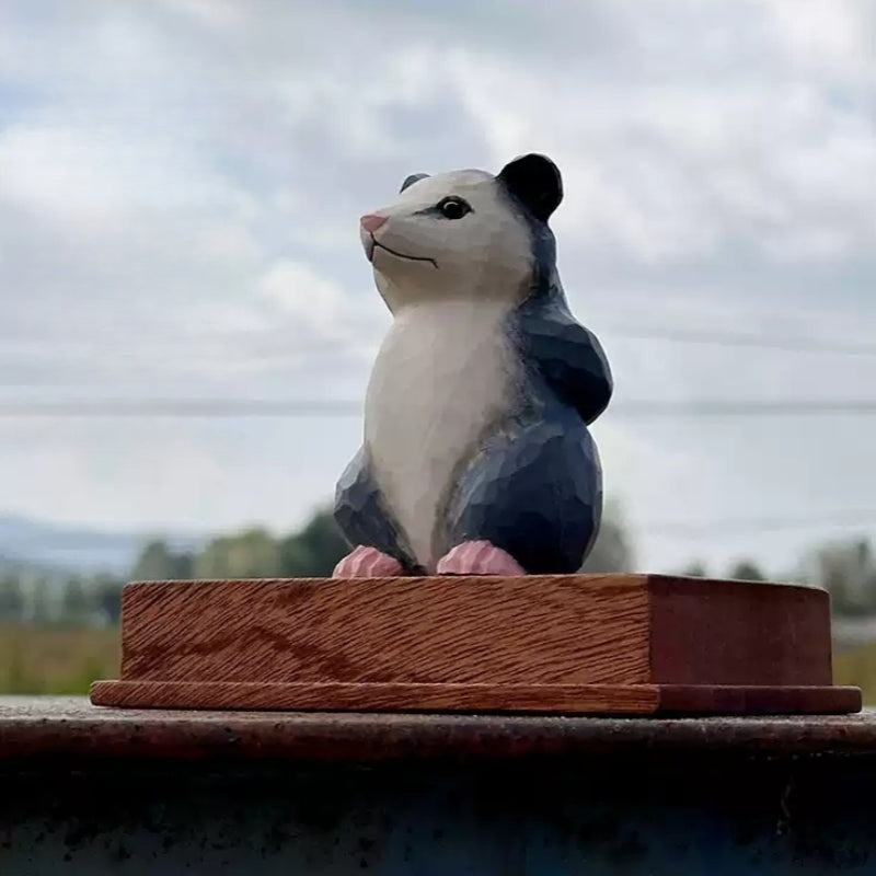 Front three-quarter view of the opossum figurine on a display base that is not included