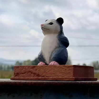 Front three-quarter view of the opossum figurine on a display base that is not included