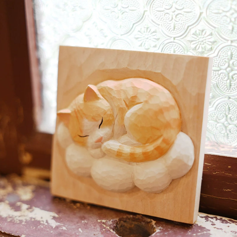 Orange cat on cloud wood relief by window