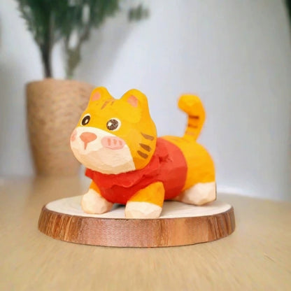 Orange tabby kitten figurine in red sweater