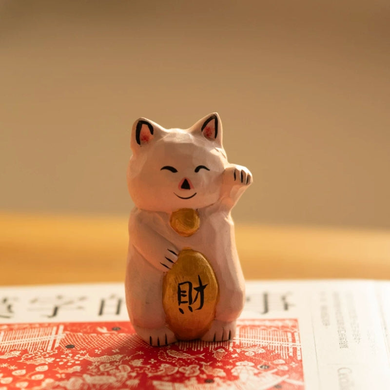 Pink maneki neko figurine with gold ingot