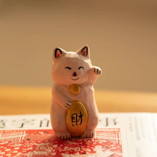 Pink maneki neko figurine with gold ingot