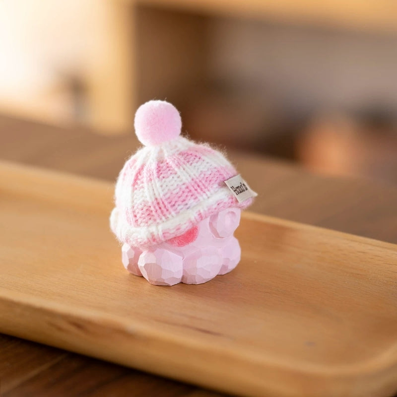 Pink octopus figurine on wooden tray