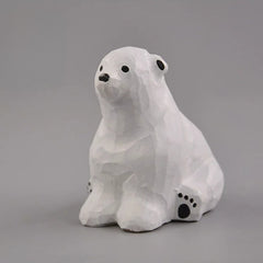 Sitting polar bear wood carving angled view